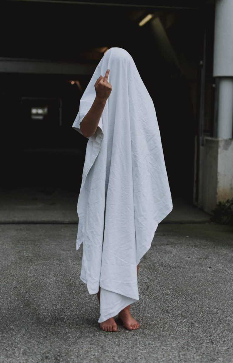 person covered by white cloth