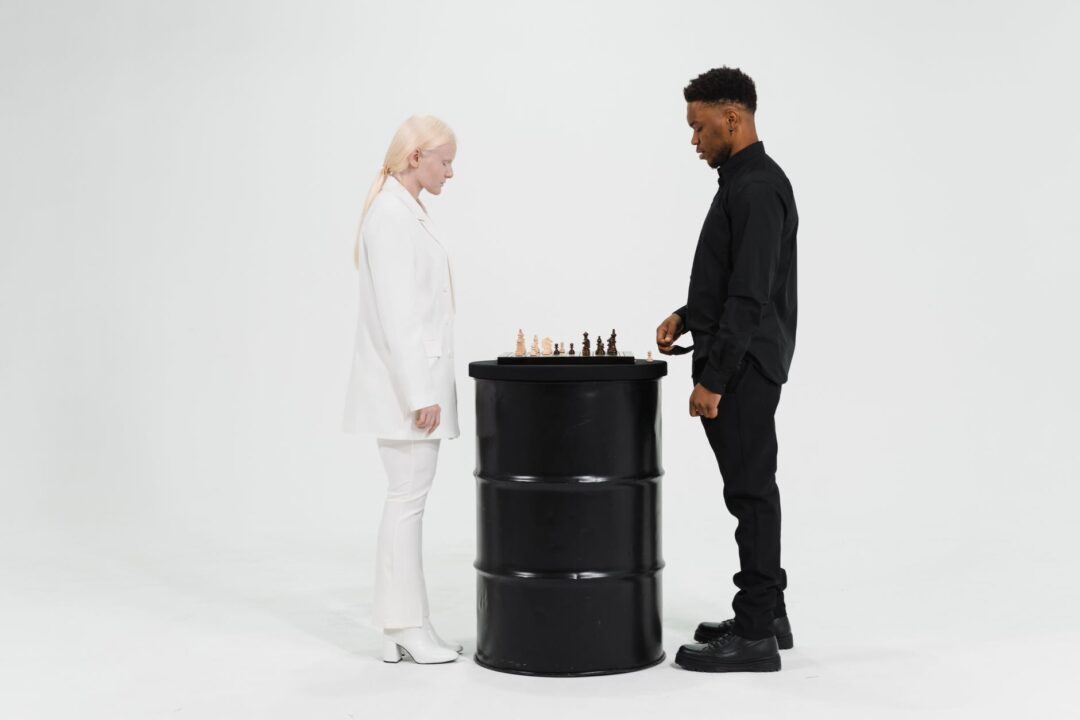 man and woman playing chess