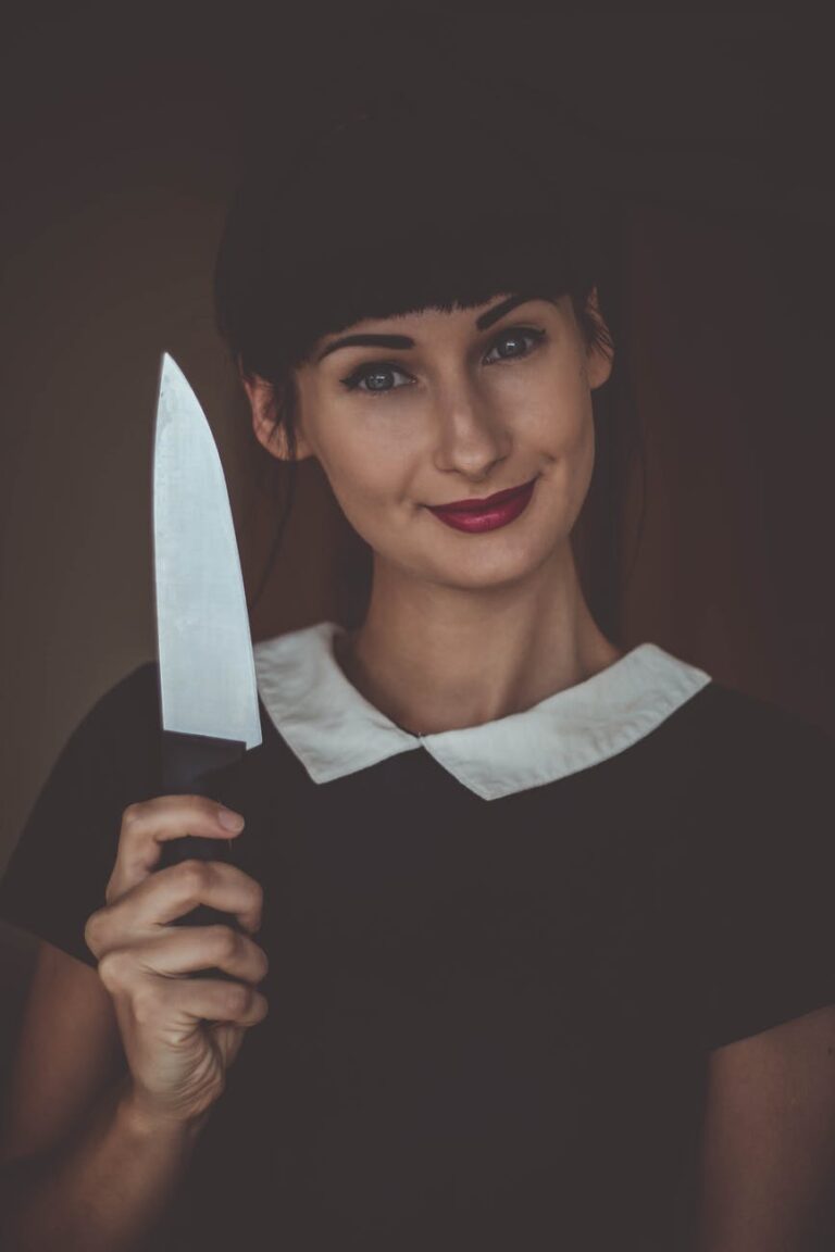 smiling woman holding knife