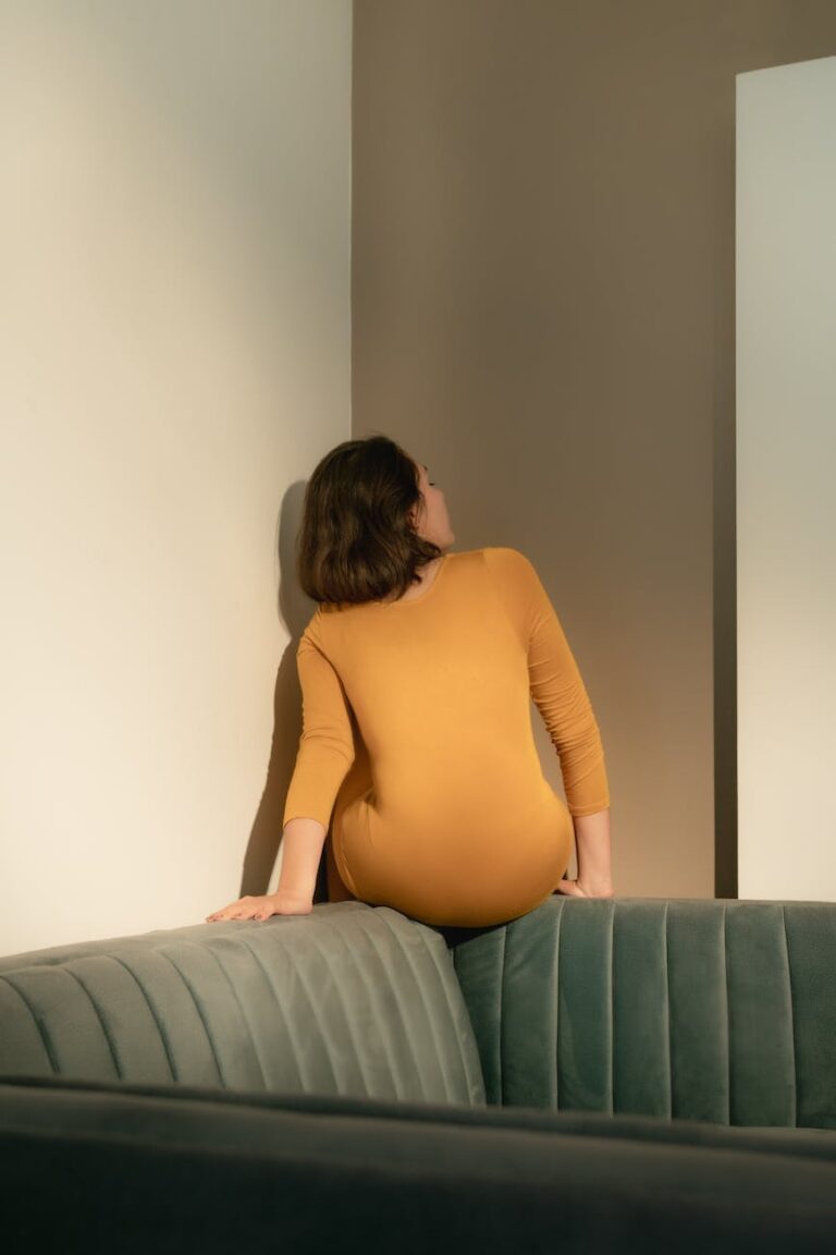 back view of a woman sitting on a sofa