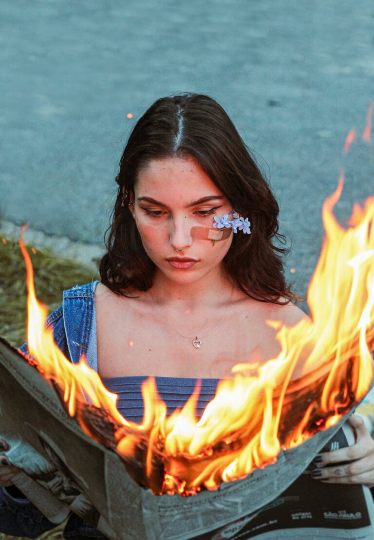 woman reading a burning newspaper