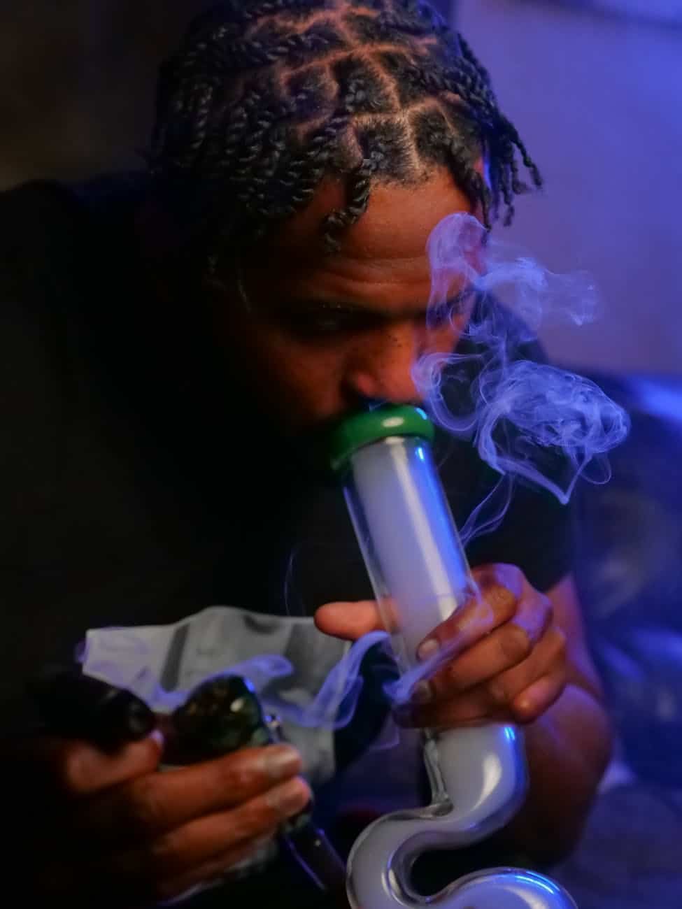 photo of man using water bong