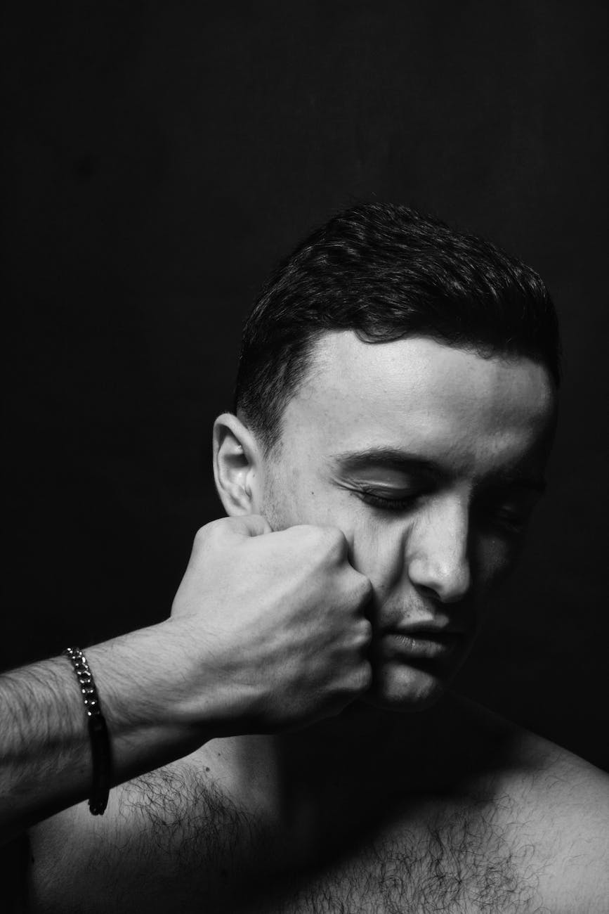 black and white shot of a man getting punched